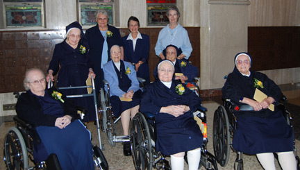 (Jubilee Sisters are wearing yellow corsages, front left to right)  Sister Regina Russell, D.C.; Sister Helen Marie Palermo, D.C.; Sister Roseann Hitchens, D.C.; (middle left to right)  Sister Clara Dunnigan, D.C.; Sister Denise Simms, D.C.; Sister Ruth Roddy, D.C.; (back left to right)  Sister Alice Marie Smith, D.C.  Sister Cora Anne Signaigo, D.C., back center, is Sister Servant at Villa Saint Michael, and Sister Sandra Goldsborough, D.C., back right, is Assistant to Sister Servant at the Villa Saint Michael.  